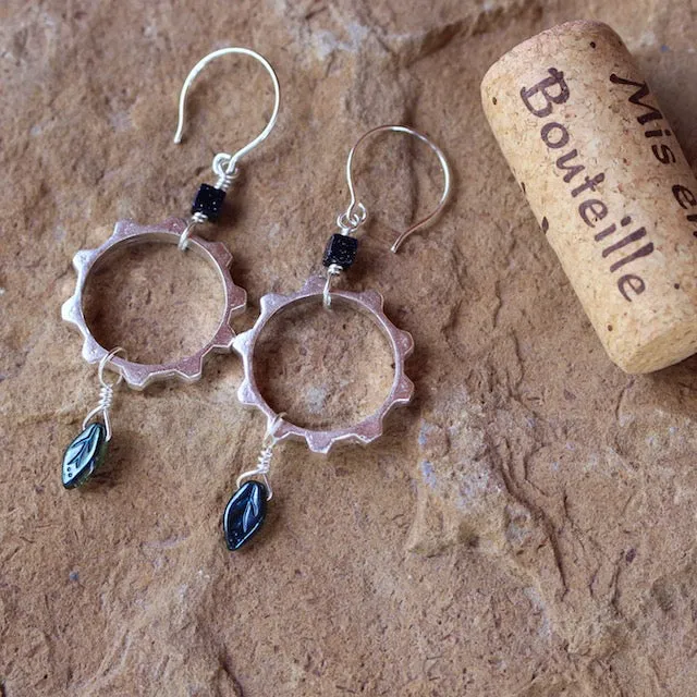 Sterling silver gear earrings with a leaf drop